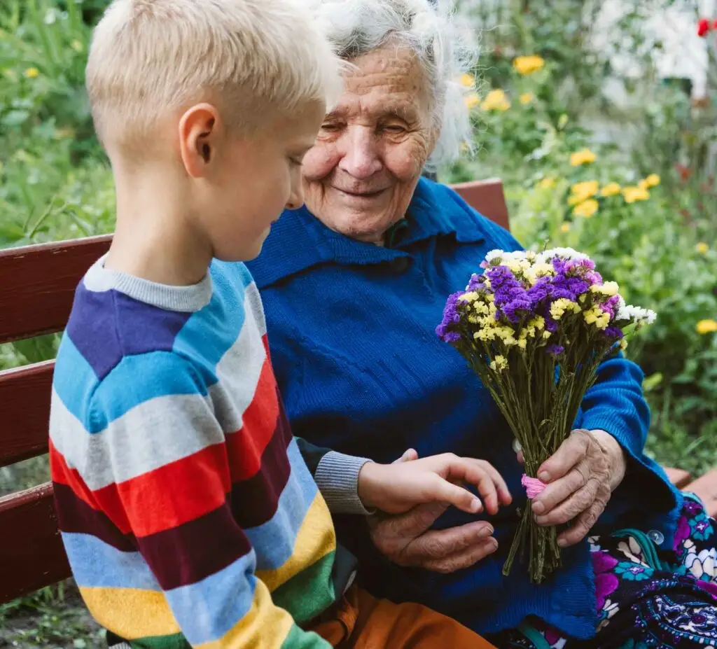 grandma holding flowers with grandson