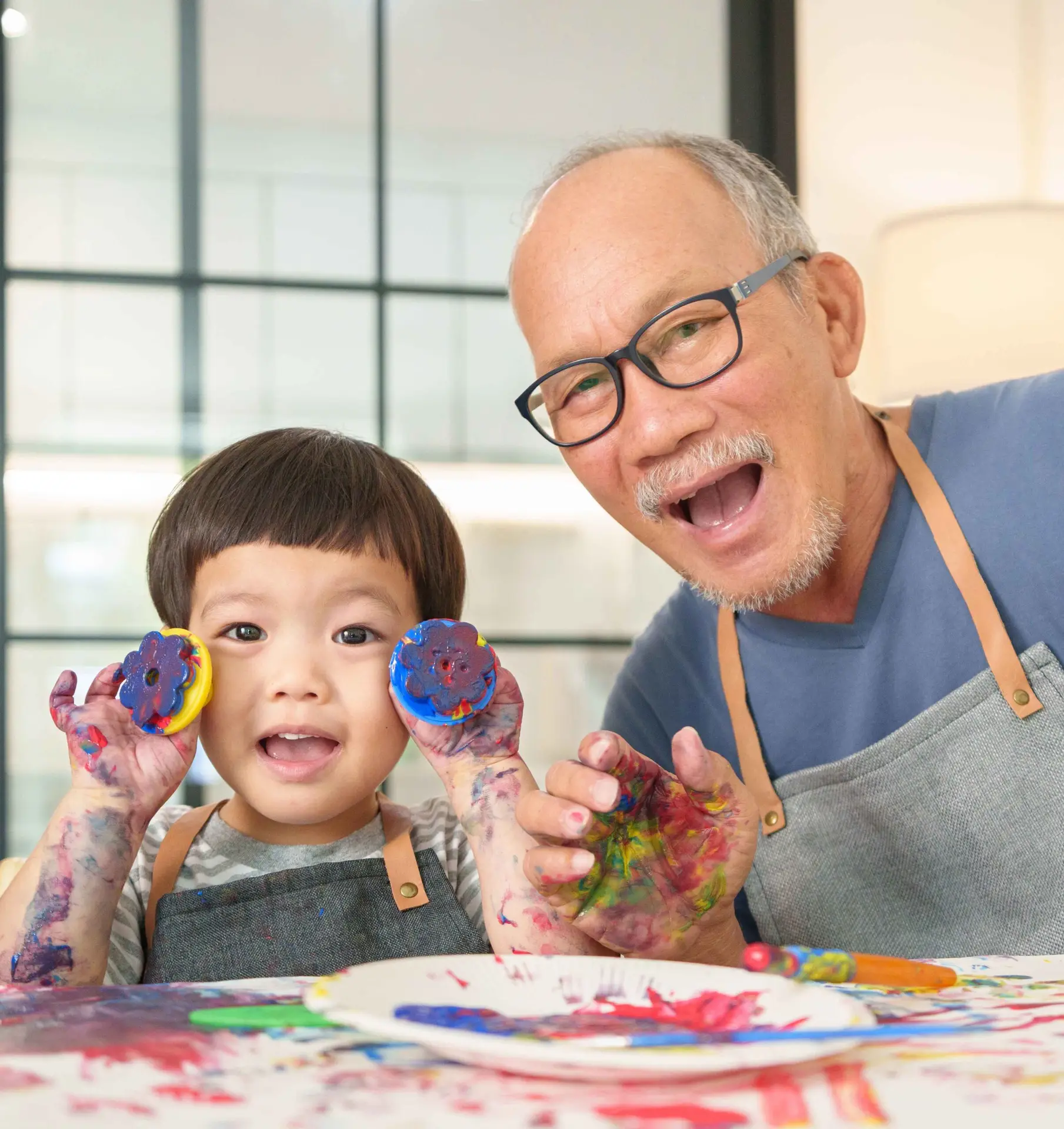 Grandpa painting with child